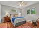 Relaxing bedroom with hardwood floors, a ceiling fan, and two bright windows, offering a comfortable and serene space at 403 Anderson St, Castle Rock, CO 80104