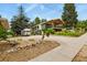 Inviting two-story green home with a covered deck and lush landscaping featuring an Airstream trailer in the driveway at 403 Anderson St, Castle Rock, CO 80104