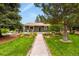 Charming one story home featuring a lush, landscaped front yard, front porch, and walkway at 403 Anderson St, Castle Rock, CO 80104
