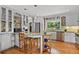Bright kitchen featuring white cabinets, stainless steel appliances, and a granite island with seating at 403 Anderson St, Castle Rock, CO 80104