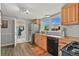 Kitchen with wood cabinets, stainless steel refrigerator, and backyard view at 403 Anderson St, Castle Rock, CO 80104