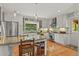 Bright kitchen featuring white cabinets, stainless steel appliances, and a granite island at 403 Anderson St, Castle Rock, CO 80104