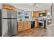 Bright kitchen with stainless steel appliances, wood cabinets, and a garden window at 403 Anderson St, Castle Rock, CO 80104