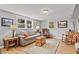 Cozy living room features a comfortable sofa, hardwood floors, and bright windows at 403 Anderson St, Castle Rock, CO 80104