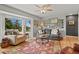 Cozy living room with large bay window, ceiling fan, comfortable seating, and hardwood floors topped with an ornate area rug at 403 Anderson St, Castle Rock, CO 80104