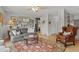 Comfortable living room featuring hardwood floors, a ceiling fan, gray sofa, an area rug, and decorative wall art at 403 Anderson St, Castle Rock, CO 80104