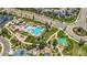 Aerial view of the community pool and park, surrounded by lush green lawns and roads at 22891 E Union Cir, Aurora, CO 80015