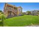 Expansive backyard with green lawn, a patio and deck with exterior siding and a wooden fence at 22891 E Union Cir, Aurora, CO 80015