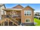 The backyard features a covered deck with a staircase down to the patio, lawn, and exterior siding at 22891 E Union Cir, Aurora, CO 80015