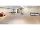 Spacious basement area featuring a play area, ping pong table and stairs, providing ample activity space at 22891 E Union Cir, Aurora, CO 80015
