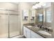 Bathroom with glass shower and double granite vanity, designed for convenience and elegance at 22891 E Union Cir, Aurora, CO 80015