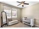 Cozy bedroom with full-length mirror and crib, offers an inviting setting for babies at 22891 E Union Cir, Aurora, CO 80015