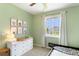 Light green bedroom with window that invites sunlight, paired with matching wall decor at 22891 E Union Cir, Aurora, CO 80015