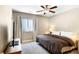 Neutral bedroom featuring a ceiling fan, a large bed, and a window with light-filtering shades at 22891 E Union Cir, Aurora, CO 80015