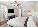 Bright bedroom featuring a ceiling fan, TV, and access to a bathroom, creating a comfortable suite at 22891 E Union Cir, Aurora, CO 80015
