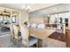 Open concept dining area with pendant lighting, seating for six, with kitchen and living areas at 22891 E Union Cir, Aurora, CO 80015