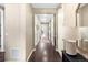 Long hallway with hardwood floors leads to various rooms, showing spaciousness of the home at 22891 E Union Cir, Aurora, CO 80015