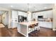 Modern kitchen featuring white cabinets, stainless steel appliances, and a center island with seating at 22891 E Union Cir, Aurora, CO 80015