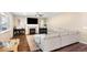 Cozy living room with a fireplace, large sectional sofa, and dark hardwood flooring at 22891 E Union Cir, Aurora, CO 80015