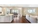 Open-concept living space with hardwood floors, adjacent kitchen, and lots of natural light at 22891 E Union Cir, Aurora, CO 80015