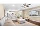 Bright and open living area with a large sectional sofa, hardwood floors, and a view into the kitchen at 22891 E Union Cir, Aurora, CO 80015