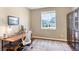 Office space with a window, wooden desk, and comfortable chair, makes working enjoyable at 22891 E Union Cir, Aurora, CO 80015