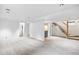 Large finished basement with neutral carpet, showcasing ample space and access to the upper levels at 1335 Jasmine St, Denver, CO 80220