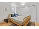 Cozy bedroom with natural light, featuring a stylish rattan bed frame and comfortable furnishings at 1335 Jasmine St, Denver, CO 80220