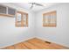 Empty room with hardwood floors, natural light, a ceiling fan, wood shutter coverings, and minimalist features at 1335 Jasmine St, Denver, CO 80220
