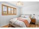 Bright bedroom with hardwood floors, a ceiling fan and a large window with wood shutter coverings at 1335 Jasmine St, Denver, CO 80220