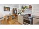 Bright, updated kitchen featuring stainless steel appliances, quartz countertops, and hardwood floors at 1335 Jasmine St, Denver, CO 80220