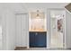 Functional laundry area featuring a sink with wood counter, cabinetry, and closet at 1335 Jasmine St, Denver, CO 80220