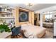Charming bedroom featuring a hidden murphy bed, desk area, and mirrored closet doors at 1833 N Williams St # 201, Denver, CO 80218