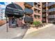 Apartment building featuring a covered entry, red brick facade, and black metal balconies at 1833 N Williams St # 201, Denver, CO 80218