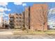 Apartment building exterior showcases brick facade and outdoor landscaping at 1833 N Williams St # 201, Denver, CO 80218