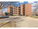 Apartment building with brick facade, balconies, and available parking at 1833 N Williams St # 201, Denver, CO 80218