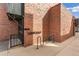 Brick building exterior with bike rack, key system, and metal staircase at 1833 N Williams St # 201, Denver, CO 80218
