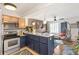Updated kitchen with two tone cabinets, stainless steel appliances, and bar seating that opens to the living area at 1833 N Williams St # 201, Denver, CO 80218