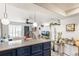 Contemporary kitchen featuring dark blue cabinets, pendant lighting and an adjacent living area at 1833 N Williams St # 201, Denver, CO 80218