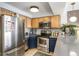 Kitchen with stainless steel appliances, light wood cabinets, and blue base cabinets at 1833 N Williams St # 201, Denver, CO 80218