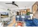Open concept living room with breakfast bar, ceiling fan, and views into the kitchen at 1833 N Williams St # 201, Denver, CO 80218