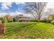 Spacious backyard showcasing lush greenery and a deck, offering a serene outdoor retreat at 3841 W Quinn Pl, Denver, CO 80236
