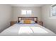 Comfortable bedroom featuring a wooden bed frame and ample natural light at 3841 W Quinn Pl, Denver, CO 80236