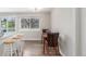 Open dining area featuring a breakfast bar, modern lighting, and a view of the greenery outdoors at 3841 W Quinn Pl, Denver, CO 80236