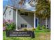 Charming home featuring a manicured front yard with flowering shrubs and a vibrant blue front door at 3841 W Quinn Pl, Denver, CO 80236