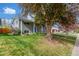 View of the well maintained lawn and garden, the covered entry, and brick facade at 3841 W Quinn Pl, Denver, CO 80236