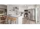 Stylish open kitchen featuring modern stainless steel appliances and white cabinets at 3841 W Quinn Pl, Denver, CO 80236
