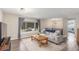 Bright living room features hardwood floors, large window, and comfortable seating area with modern lighting at 3841 W Quinn Pl, Denver, CO 80236