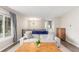 Bright living room with modern decor, a large window, and hardwood floors at 3841 W Quinn Pl, Denver, CO 80236
