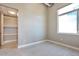 Well-lit bedroom with closet, bright window, and light grey tile floor at 1475 Delgany St # 807, Denver, CO 80202